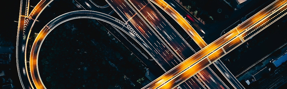 Night highway from above with light streaks